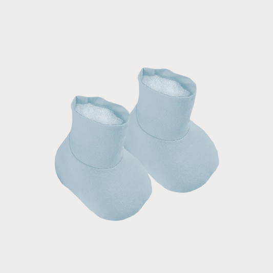 a pair of baby blue booties lie side by side