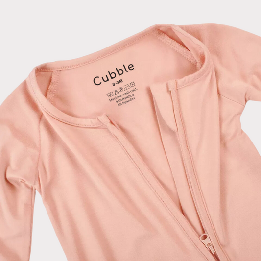 a pink sleepsuit with its zipper half open