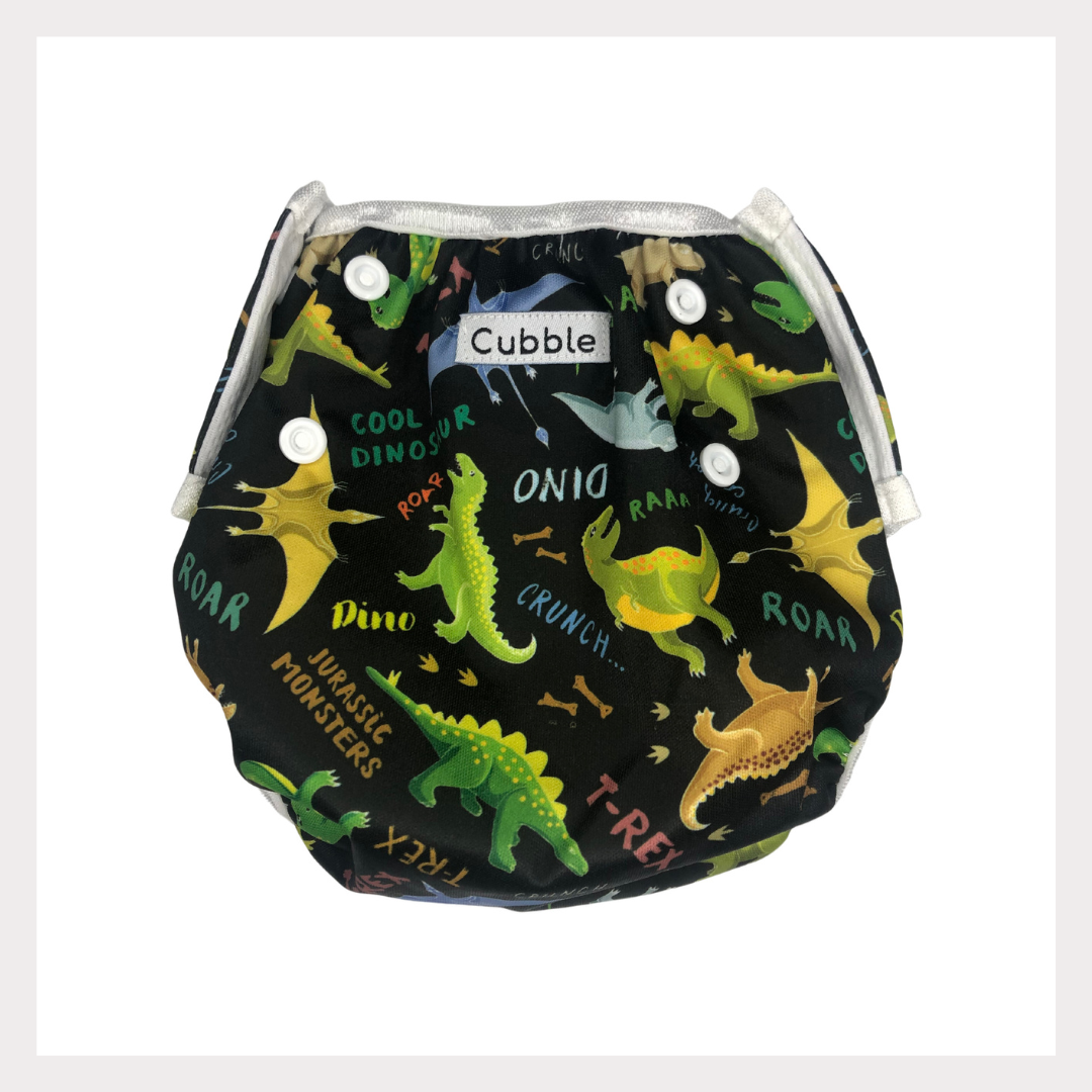 a swim diaper with a dinosaur design and words that say "jurassic monsters"