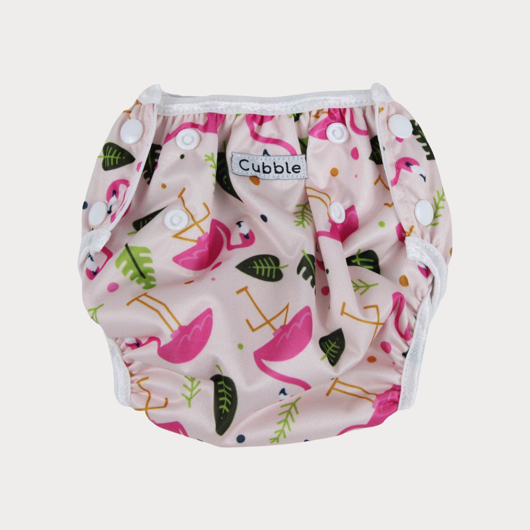 a swim diaper with a bright pink flamingo design