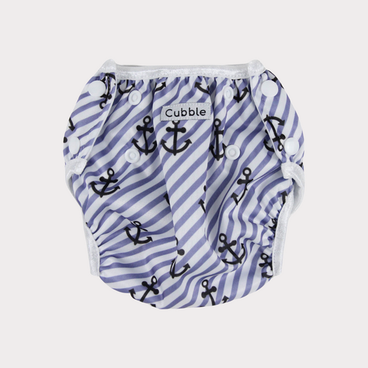a swim diaper with a blue and black anchor stripe design