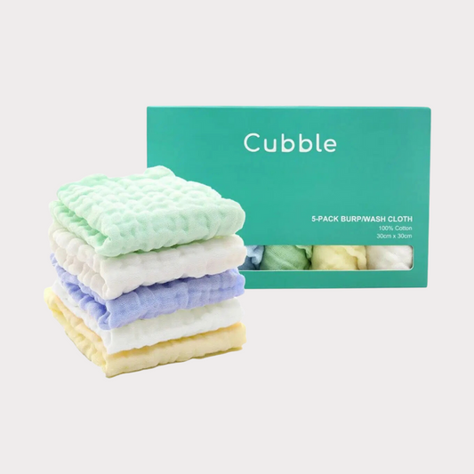 a stack of five muslin cloths are right next to a box packaging