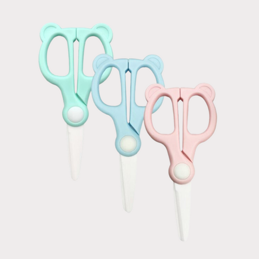 three pairs of ceramic food scissors in green, blue and pink